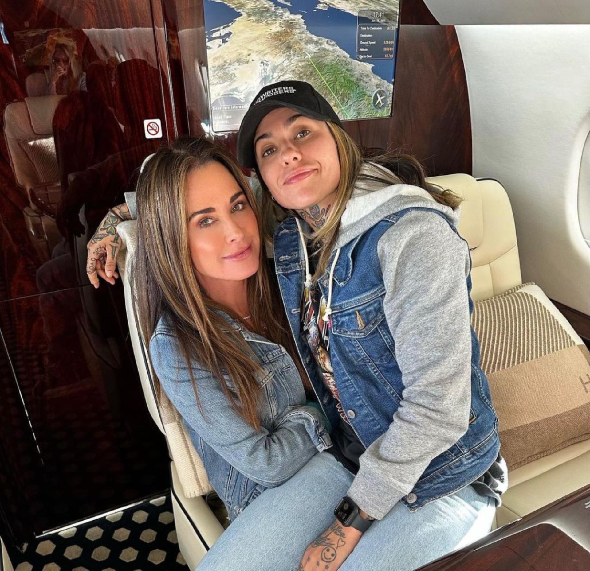 Morgan Wade sitting in Kyle Richards' lap.