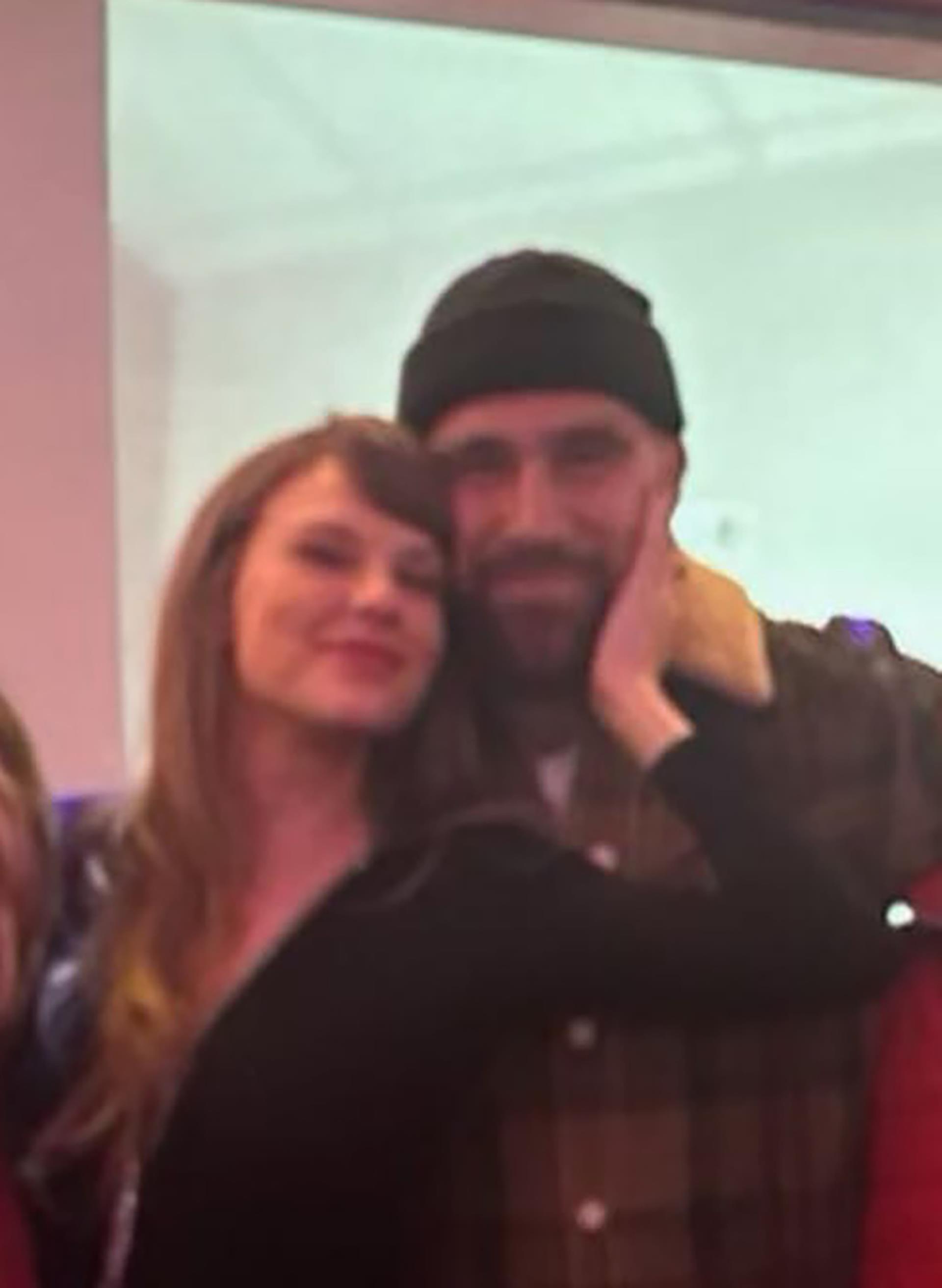 Taylor Swift and Travis Kelce at a holiday party.