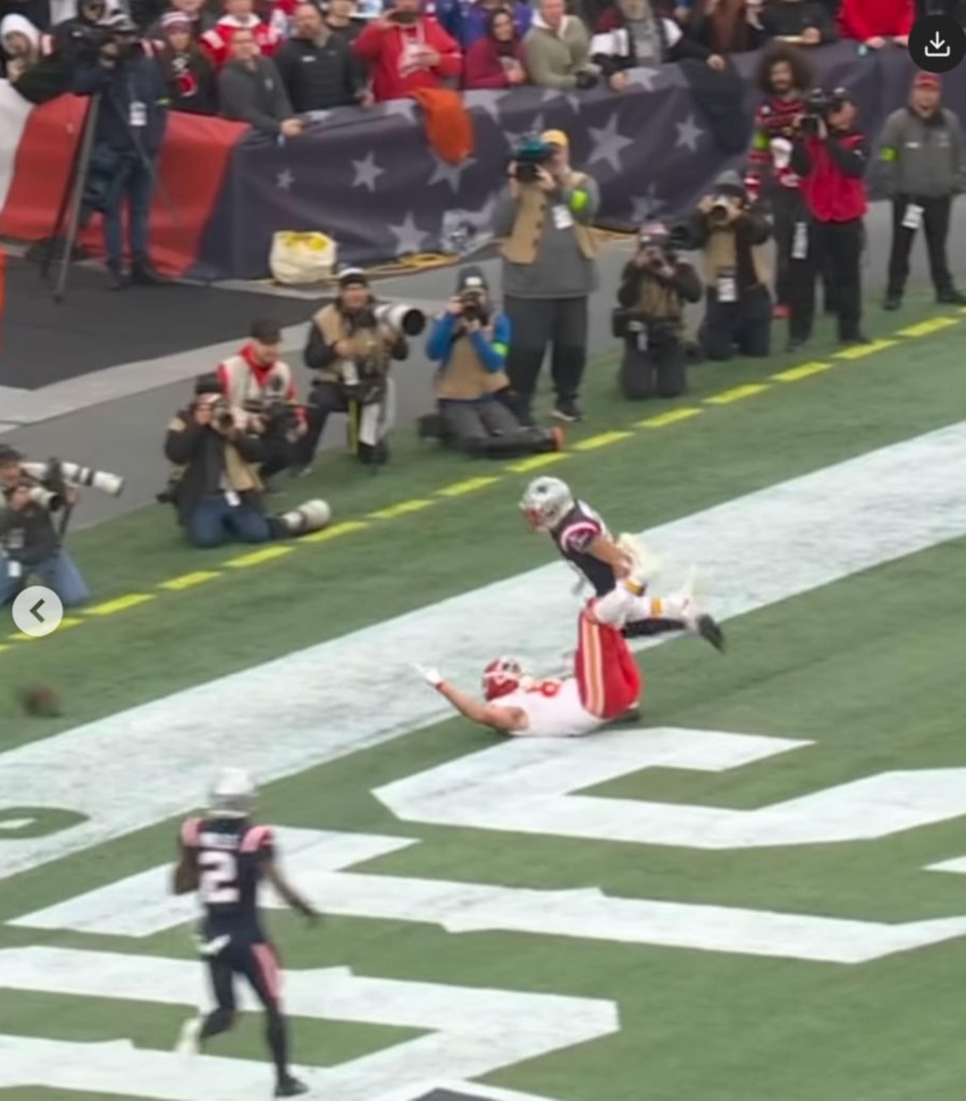 Travis Kelce being pushed by Myles Bryant.